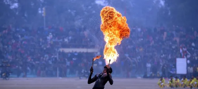 An Indian artist from Central Reserve Police Force (CRPF) spits fire as he performs Karakattam folk dance while he takes part in India's 67th Republic Day celebrations in Jammu, the winter capital of Kashmir, India 26 January 2016. India celebrates the day its constitution was adopted – January 26, 1950 – as Republic Day. (Photo by Jaipal Singh/EPA)