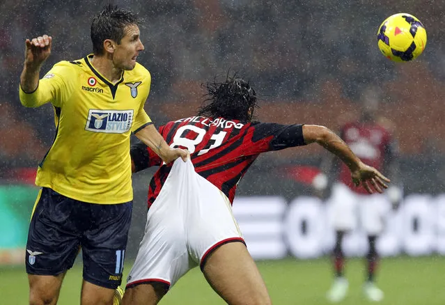 AC Milan's Cristian Zaccardo (R) fights for the ball with Lazio's Miroslav Klose during their Italian Serie A soccer match at San Siro stadium in Milan October 30, 2013. (Photo by Alessandro Garofalo/Reuters)