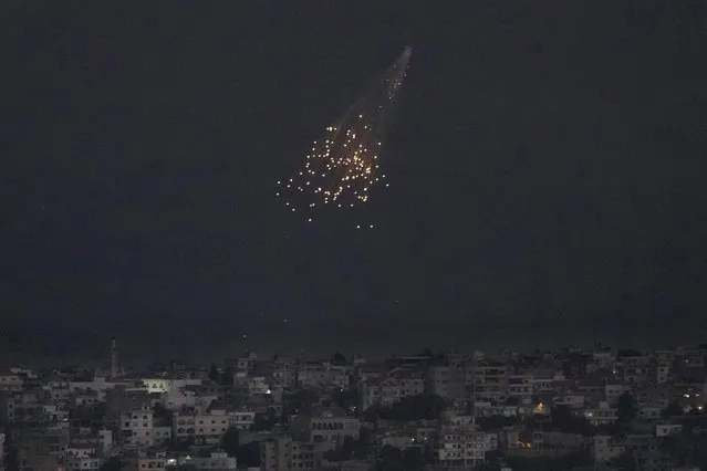 A shell from Israeli artillery explodes over Bastra Farms in the disputed Shebaa Farms territory, south Lebanon, Tuesday, October 10, 2023. A Lebanese security official said six rockets were fired from southern Lebanon into northern Israel Tuesday evening. (Photo by Hussein Malla/AP Photo)