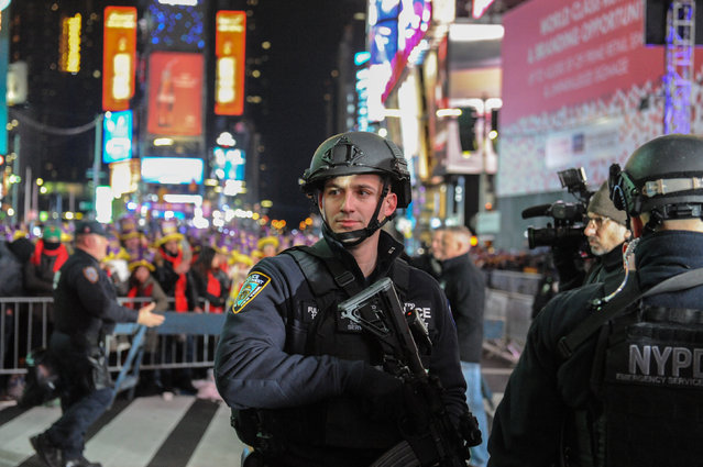 A member of the counter terrorism task force stands guard in Times Square on New Year's Eve in New York, U.S. December 31, 2016. (Photo by Stephanie Keith/Reuters)