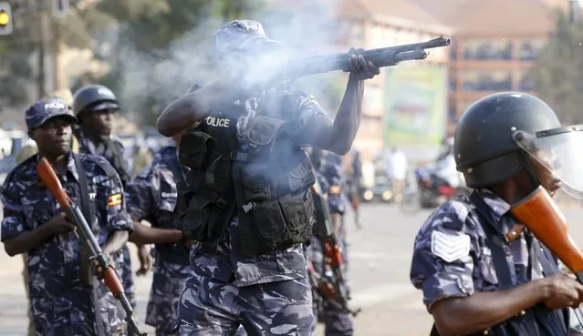 Riot police fire tear gas at Uganda's leading opposition party Forum for Democratic Change supporters as police and military forces disperse their procession with their presidential candidate to a campaign ground, in Kampala, Uganda, February 15, 2016. (Photo by James Akena/Reuters)