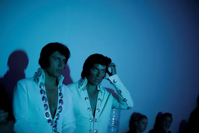 Ultimate Elvis tribute artist competitors Nick Nicolas (L) and Brendon Chase watch from off stage as a rival performs in the final round of the contest at the 25th annual Parkes Elvis Festival in the rural Australian town of Parkes, west of Sydney, January 14, 2017. (Photo by Jason Reed/Reuters)