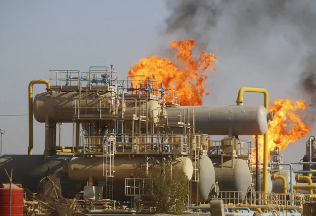 Flames emerge from a pipeline at the oil fields in Basra, southeast of Baghdad, Iraq October 14, 2016. (Photo by Essam Al-Sudani/Reuters)