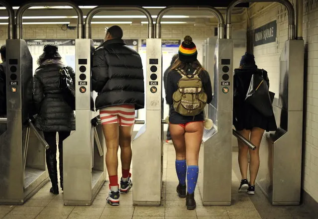 Some riders enter the New York subway in their underwear as they take part in the 2014 No Pants Subway Ride on January 12, 2014. (Photo by Timothy Clary/AFP Photo)
