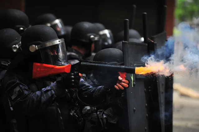 Riot police fire tear gas as they clash with civil servants protesting against austerity measures in front of the Rio de Janeiro State Legislative Assembly in Rio de Janeiro, Brazil, on February 1, 2017. (Photo by Fabio Teixeira/Anadolu Agency/Getty Images)