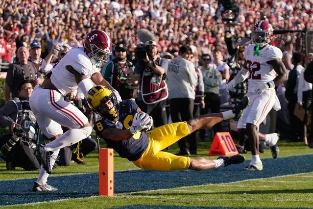 Michigan wide receiver Tyler Morris (8) scores a touchdown past Alabama defensive back Jaylen Key (6) and linebacker Deontae Lawson (32) and during the first half of the Rose Bowl CFP NCAA semifinal college football game Monday, January 1, 2024, in Pasadena, Calif. (Photo by Mark J. Terrill/AP Photo)
