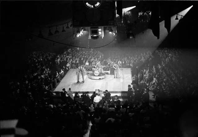 The Beatles perform at the Coliseum in Washington, D.C., February 12, 1964, during their first American tour.  The British band members are, in foreground, Paul McCartney and John Lennon; Ringo Starr on drums; and George Harrison on guitar, far right. (Photo by AP Photo)