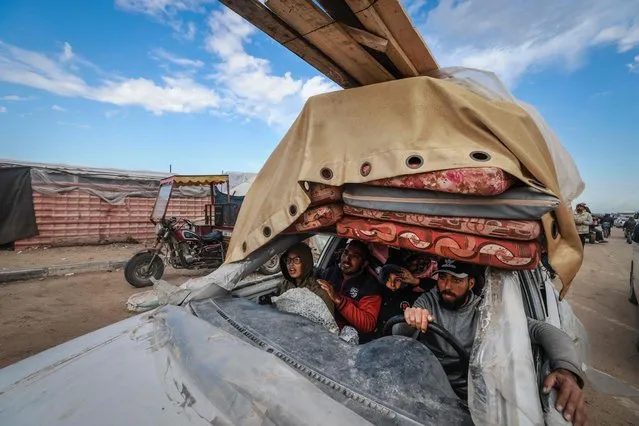 Palestinians fleeing Khan Yunis arrive in Rafah with their belongings in a damaged car on February 15, 2024, as battles raged in the sourthern Gaza Strip between Israel and the Palestinian militant group Hamas. (Photo by Mohammed Abed/AFP Photo)