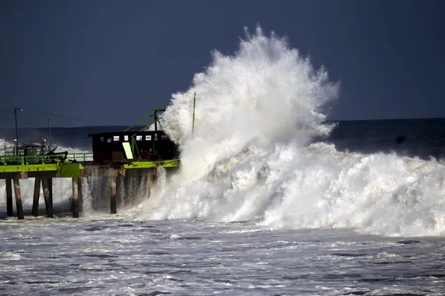 A wave crashes on a fishing dock at La Libertad May 3, 2015. (Photo by Jose Cabezas/Reuters)