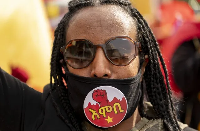 A woman participates in a protest march to mark a year since Ethiopia Prime Minister Abiy Ahmed's administration started fighting against the Tigray, the northernmost region in Ethiopia, in Washington, Thursday, November 4, 2021. (Photo by Gemunu Amarasinghe/AP Photo)