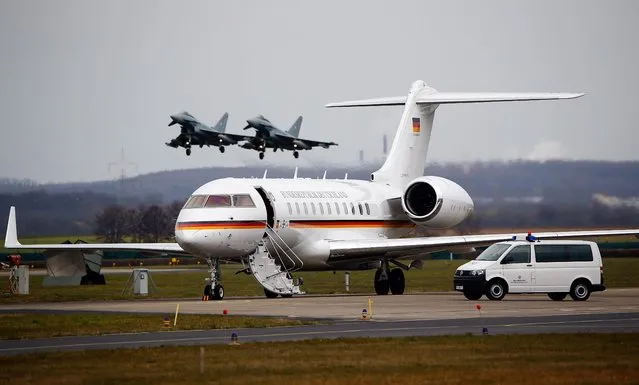 Two Eurofighter jets take off next to the plane of German Chancellor Angela Merkel during Merkel's visit at the German Luftwaffe airbase “Air Force wing 31” in Noervenich near Cologne, Germany, March 21, 2016. (Photo by Wolfgang Rattay/Reuters)