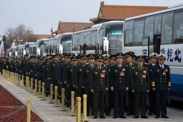 Chinese military officers line up to attend a preparatory session of the National People's Congress (NPC) outside the Great Hall of the People in Beijing, Monday, March 4, 2024. (Photo by Andy Wong/AP Photo)