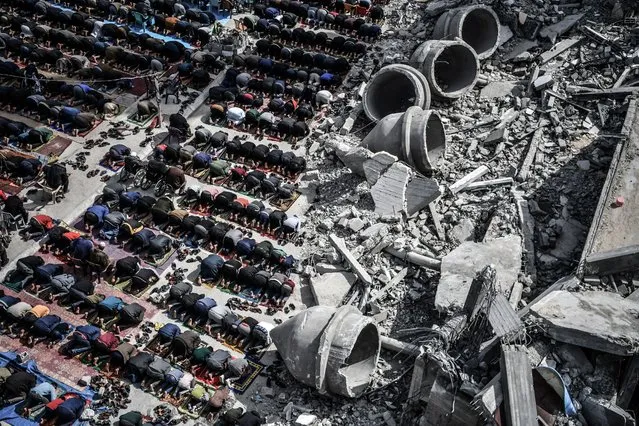 An aerial view of Palestinians performing Friday prayers among the rubble of the Al-Farooq Mosque, destroyed in an Israeli attack on March 01, 2024 in Rafah, Gaza. (Photo by Abed Zagout/Anadolu via Getty Images)