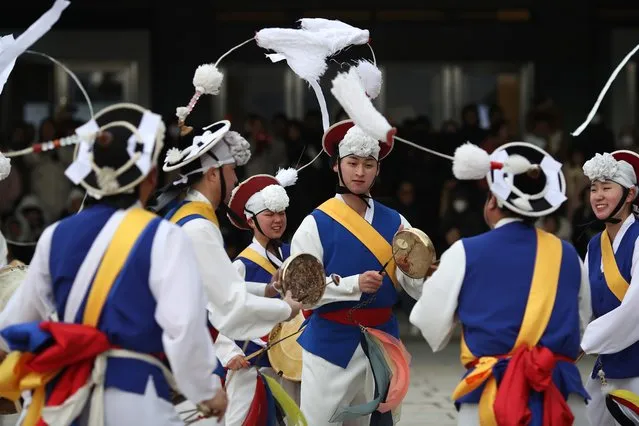 South Korean performers wearing traditional clothes participate in a traditional game for wishing good luck in Lunar New Year holiday at the National folk museum of Korea inside of the Gyeongbokgung royal palace on February 11, 2024 in Seoul, South Korea. Korean people travel from large cities to their hometowns for the Lunar New Year holidays to pay respect to the spirits of their ancestors. (Photo by Chung Sung-Jun/Getty Images)