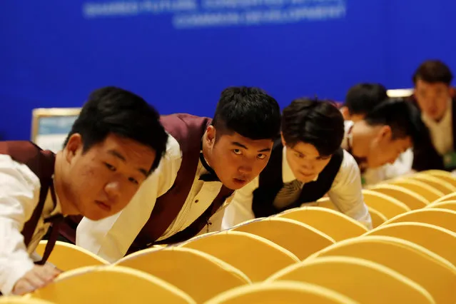 Staff members prepare the seats at a hall before the Boao Forum for Asia in Qionghai, Hainan province, CHina March 25, 2019. (Photo by Reuters/China Stringer Network)