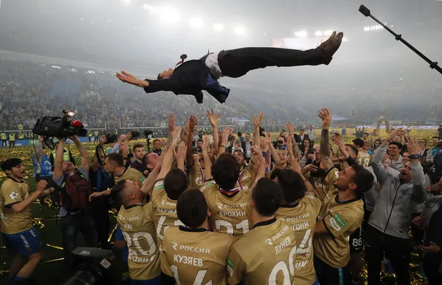 Players of FC Zenit St. Petersburg throw into the air Head coach Sergei Semak and celebrate after winning the Russian Premier League title, following the match against FC CSK Moscow, in St. Petersburg, Russia, 12 May 2019. (Photo by Anatoly Maltsev/EPA/EFE)