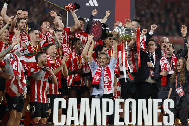 Athletic Bilbao's Spanish coach Ernesto Valverde holds the Copa del Rey trophy at the end of the Spanish Copa del Rey (King's Cup) final football match between Athletic Club Bilbao and RCD Mallorca at La Cartuja stadium in Seville on April 6, 2024. (Photo by Jaime Reina/AFP Photo)