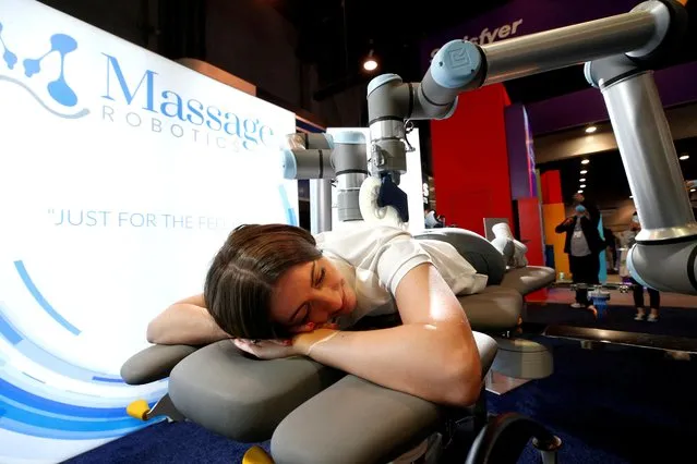 Kirsten Mackin gets a massage at the Massage Robotics booth during CES 2022 at the Las Vegas Convention Center in Las Vegas, Nevada, U.S. on January 6, 2022. (Photo by Steve Marcus/Reuters)