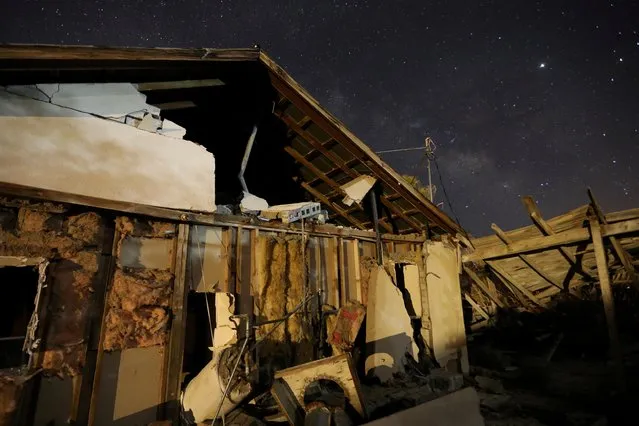 A house left destroyed by a powerful magnitude 7.1 earthquake, triggered by a 6.4 the previous day, is seen at night near the epicenter in Trona, California, U.S., July 6, 2019. (Photo by David McNew/Reuters)