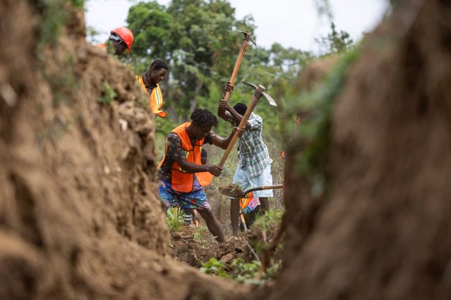 Residents of the Malfety neighborhood work on the construction of an irrigation canal in Fort Liberte, Haiti on April 27, 2024. (Photo by Ricardo Arduengo/Reuters)
