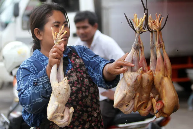 A woman sells chickens at a market in Phnom Penh, Cambodia February 2, 2017. (Photo by Samrang Pring/Reuters)