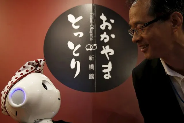 SoftBank's human-like robot named “Pepper” speaks to a customer in its role as a PR manager of Tottori prefecture at the prefecture speciality store in Tokyo, Japan, July 1, 2015. (Photo by Yuya Shino/Reuters)