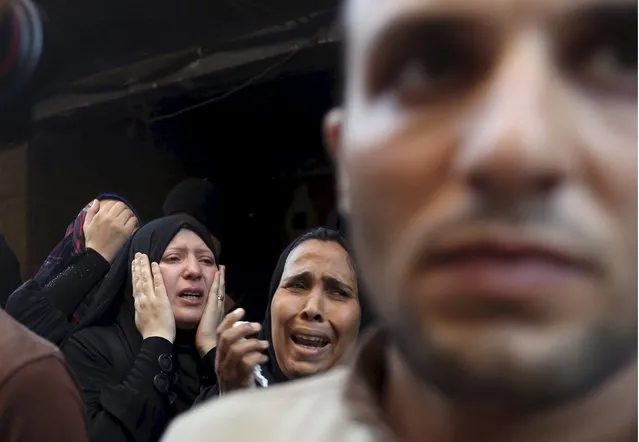 Relatives of 21-year-old Mohamed Adel, one of the army officers who died in yesterday's Sinai attacks, cry during the funeral in Al-Kaliobeya, near Cairo, Egypt, July 2, 2015. (Photo by Mohamed Abd El Ghany/Reuters)