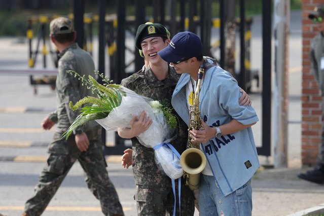 K-pop boy band BTS member Jin is greeted by a group member RM after being discharged from the military in Yeoncheon, South Korea, on June 12, 2024. (Photo by Yonhap via Reuters)