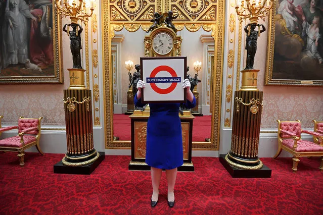 Sally Goodsir, Assistant Curator of Decorative Arts, holds a London Underground sign presented to Queen Elizabeth in 2010, one of the items of the Royal Gifts exhibition which goes on public display from July 22 at the Summer Opening of the State Rooms at Buckingham Palace, London, Britain, April 3, 2017. (Photo by Toby Melville/Reuters)