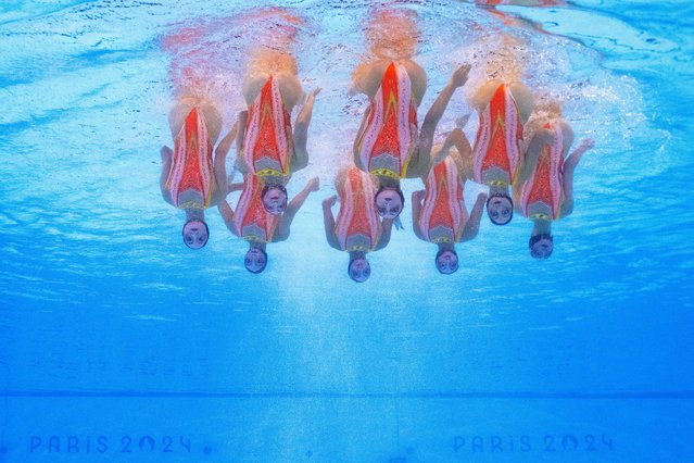 An underwater view shows Team France competing in the team free routine of the artistic swimming event during the Paris 2024 Olympic Games at the Aquatics Centre in Saint-Denis, north of Paris, on August 6, 2024. (Photo by Manan Vatsyayana/AFP Photo)