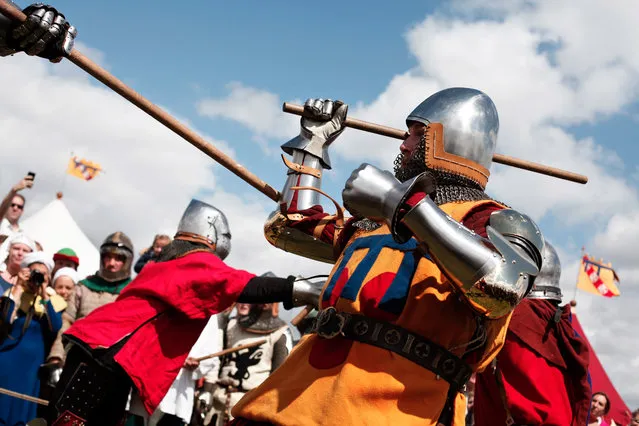 People fight during the reenactment of a tournament of knights fight, in Agincourt, northern France, Saturday, July 25, 2015. (Photo by Thibault Camus/AP Photo)