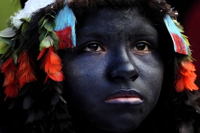 An Indigenous girl prepares to take part in a ritual during the final and most symbolic day of the Wyra'whaw coming-of-age festival at the Ramada ritual center, in the Tenetehar Wa Tembe village, located in the Alto Rio Guama Indigenous territory in Para state, Brazil, Sunday, June 11, 2023. (Photo by Eraldo Peres/AP Photo)