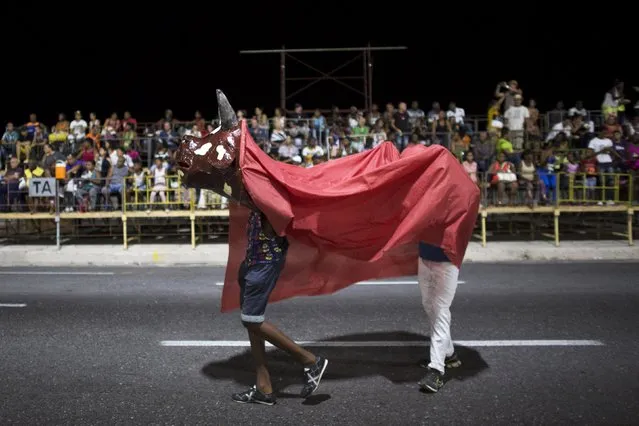 Revelers wear a cow costume during a carnival parade in Havana, Cuba August 7, 2015. (Photo by Alexandre Meneghini/Reuters)