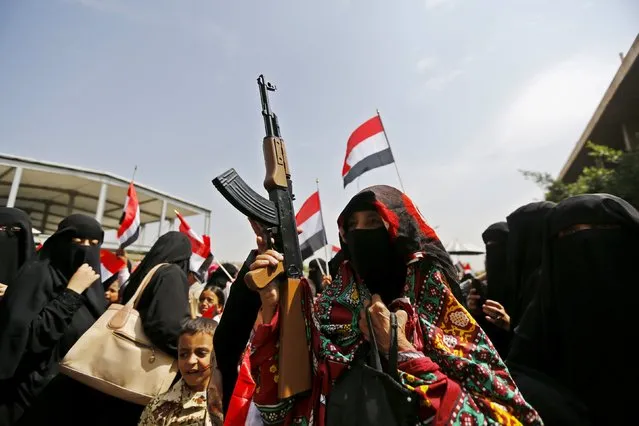 A woman holds a toy rifle during a protest against the Saudi-led coalition outside the offices of the United Nations in Yemen's capital Sanaa August 11, 2015. A political crisis descended into civil war in March when Iranian-allied Houthi forces who had seized the capital Sanaa advanced south towards the main port of Aden, forcing President Abd-Rabbu Mansour Hadi to flee to Saudi Arabia. (Photo by Khaled Abdullah/Reuters)