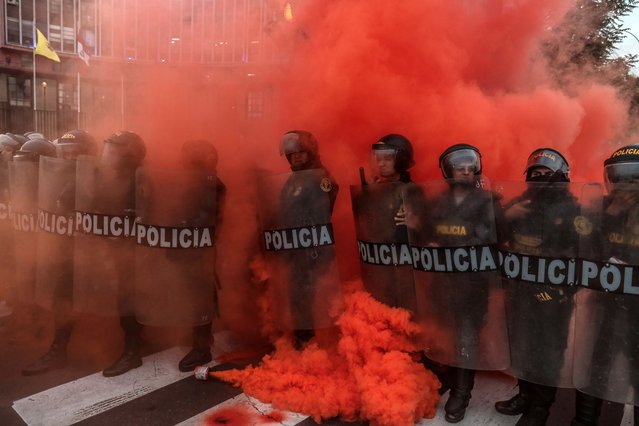 Police clash with demonstrators during protests calling for the resignation of the Peruvian President and the closure of Congress, in Lima, Peru on July 19, 2023. The Peruvian National Police (PNP) removed the protesters who arrived outside the Congress and directed them to other points in the center of Lima, at the end of the protest march called by social groups to demand the resignation of the Peruvian President. (Photo by Aldair Mejia/EPA)