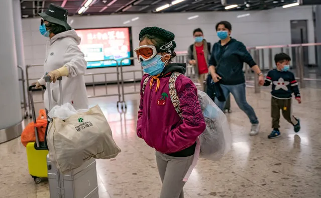 A girl wearing ski goggles and protective mask exits the arrival hall at Hong Kong High Speed Rail Station on January 29, 2020 in Hong Kong, China. (Photo by Anthony Kwan/Getty Images)