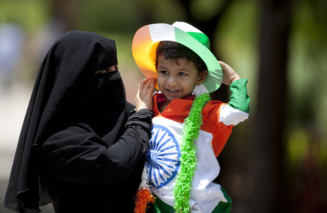 An Indian Muslim woman carries her son dressed in tricolor during Independence Day celebrations in Hyderabad, Tuesday, August 15, 2017. India commemorates its Independence in 1947 from British colonial rule on Aug. 15. (Photo by Mahesh Kumar A./AP Photo )