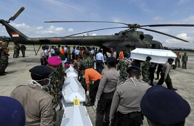 Indonesian security forces and rescue teams unload coffins from a military helicopter containing the remains of passengers recovered from the crash site of the Trigana Air passenger plane at Sentani Airport, near Jayapura, Papua province, Indonesia, August 20, 2015 in this photo taken by Antara Foto. All 54 people on board the Trigana Air aircraft were killed in the crash in Indonesia's Papua province, the latest in a string of aviation disasters in the Southeast Asian archipelago, officials said. (Photo by Andika Wahyu/Reuters/Antara Foto)