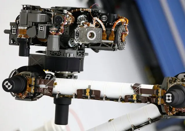 The hand lens imager is mounted on the arm of NASA's Mars rover Curiosity at the Jet Propulsion Laboratory in Pasadena, California, on April 4, 2011. The imager will take extreme close-up pictures of the planet's rocks and soil, as well as any ice it may find there. (Photo by Damian Dovarganes/AP Photo)