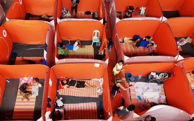 Homeless Filipinos rest on modular tents at gymnasium turned into a temporary evacuation center in Manila, Philippines, 23 March 2020. Philippine Congress' House Committee of the Whole on 23 March passed a bill granting President Rodrigo Duterte more powers during the national emergency amid the ongoing coronavirus pandemic crisis. (Photo by Francis R. Malasig/EPA/EFE/Rex Features/Shutterstock)