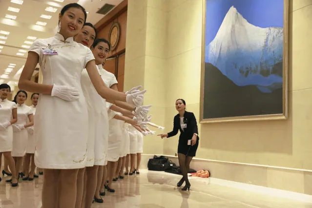 Hostesses pose for photos during a break from the G20 Finance Ministers and Central Bank Governors meeting in Chengdu in Southwestern China's Sichuan province, Sunday, July 24, 2016. Finance Ministers and Central Bank Governors of the 20 most developed economies met in the southwestern city of Chengdu ahead of a G20 leaders meeting in September hosted by China. (Photo by Ng Han Guan/AP Photo)