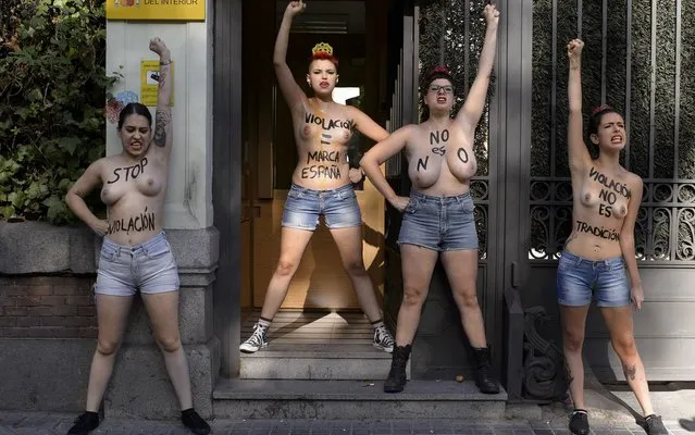 Spanish leader of feminist movement FEMEN Lara Alcazar (L) and other members gestures during a demonstration staged in front the Ministry of the Interior in Madrid on August 28, 2014. Written on their bodies you can read “Stop rape”, “Rape=Spanish brand”, “No is no” and “Rape, is not a tradition”. (Photo by Dani Pozo/AFP Photo)