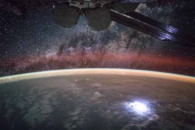 A large lightning strike on Earth lights up solar panels on the International Space Station in this NASA picture taken by astronaut Kjell Lindgren released September 2, 2015. (Photo by Kjell Lindgren/Reuters/NASA)