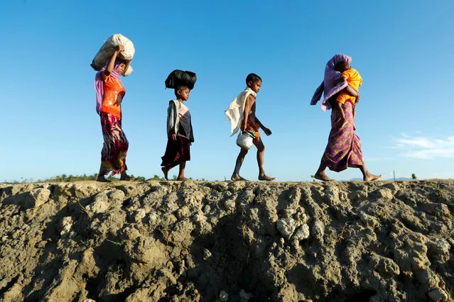 Rohingya refugees arrive at a beach after crossing from Myanmar, in Teknaf, Bangladesh October 15, 2017. (Photo by Jorge Silva/Reuters)