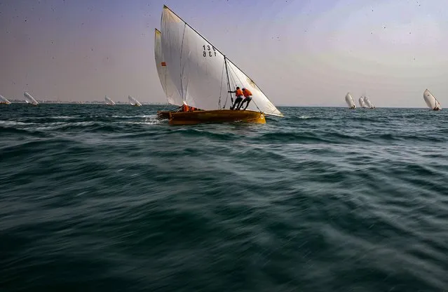 Participants compete in the Dubai Traditional Dhow Sailing Race at Dubai Inshore, United Arab Emirates, 18 September 2022. The race started the watersports season of the Dubai International Marine Club. (Photo by Ali Haider/EPA/EFE)