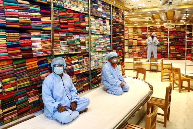 Salesmen sit idle inside a shop without customers as shopping malls reopened after the government has eased the restrictions amid concerns over the coronavirus disease(COVID-19) outbreak in Dhaka, Bangladesh on May 11, 2020. (Photo by Mohammad Ponir Hossain/Reuters)