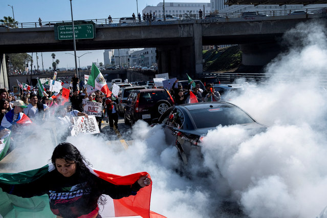 People walk along U.S. Route 101 during a protest against arrests and deportations of migrants by U.S. government agencies in Los Angeles, California, U.S. February 2, 2025. (Photo by Joel Angel Juarez/Reuters)