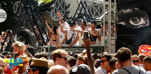 Revellers dance on a float during the Street Parade dance music event in Zurich, Switzerland August 13, 2016. (Photo by Arnd Wiegmann/Reuters)