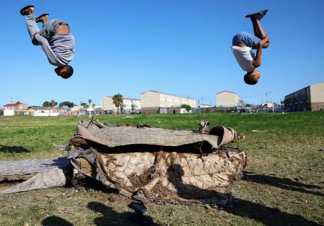 Boys playing on old mattresses in Hanover Park, an area affected by ongoing gang violence in Cape Town, South Africa on September 28, 2022. (Photo by Esa Alexander/Reuters)