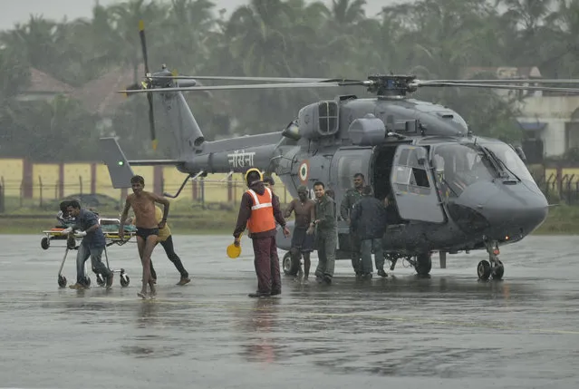 Indian fishermen who were stranded in the Arabian Sea get down from an Indian Navy helicopter after they were rescued in Thiruvananthapuram, Kerala state, India, Friday, December 1, 2017. Dozens of fishermen were rescued from the sea which is very rough under the influence of Cyclone Ockhi. (Photo by AP Photo/Stringer)